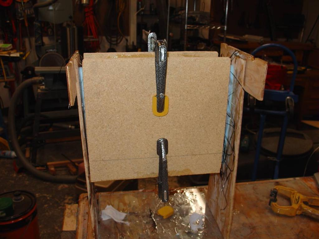 Clamp the saddles on the lay-up with only a small amount of pressure. Two clamps will do. The objective is to keep the lay-up against the foam blank.