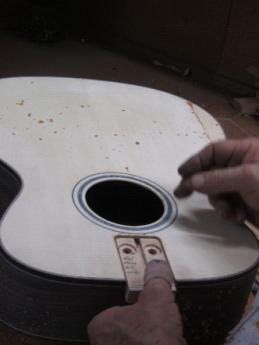 It just has to be deep enough to ensure that the neck extension block is not proud of the top of the guitar.