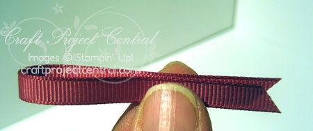 ribbon in half and feed through Pewter jumbo eyelets.