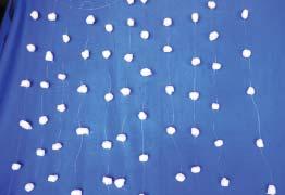Tie twelve sets White balloons in two sizes, small and large String Heavy adhesive tape Cottonball curtain in the same way. With adhesive tape, join six sets together to make a V.