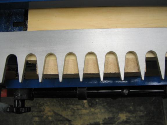 Turn on the router and machine the tails, beginning from the left side of the workpiece.