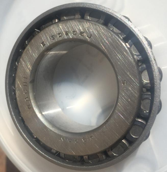 Here is the upper bearing degreased and ready to be repacked. Using my fingers, I pushed in grease from one side and watched the progress on the other side. It didn't take long to fill up the bearing.