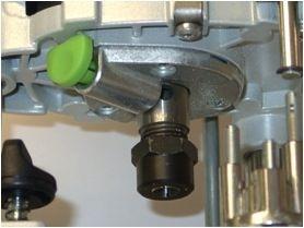 It locks the spindle in place so that the collet can be undone or done up to remove or insert router cutters.