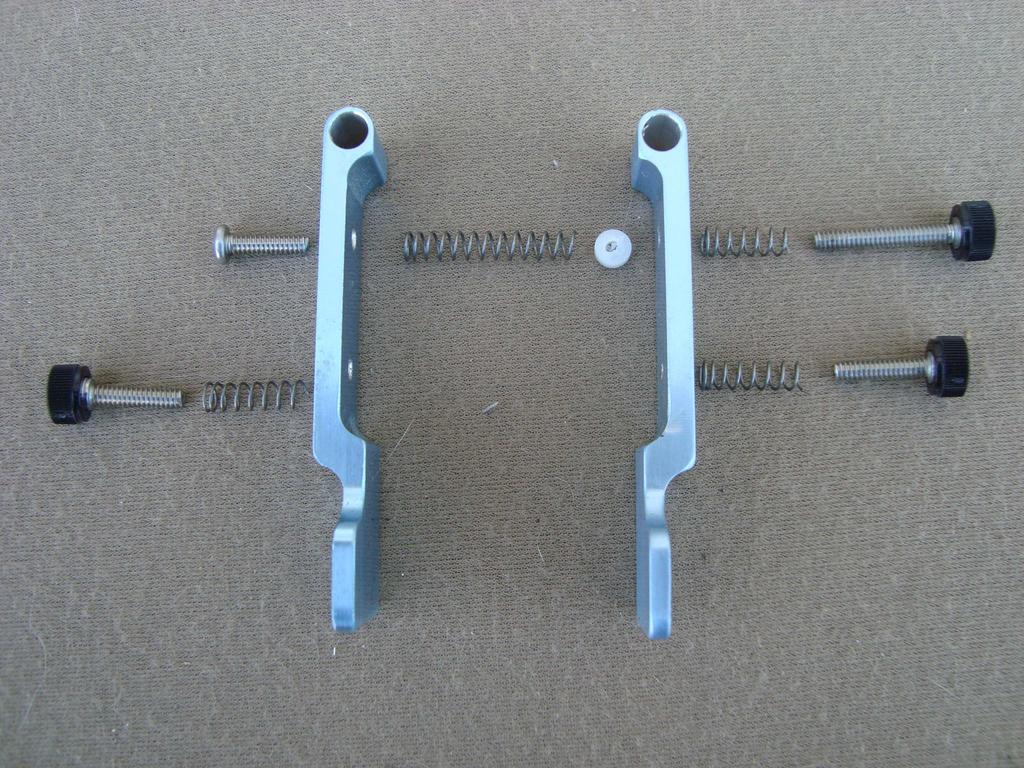 Locate the white Delrin 4-40 nut: thread the nut onto the long 4-40 adjustment thumbscrew in the right lever.