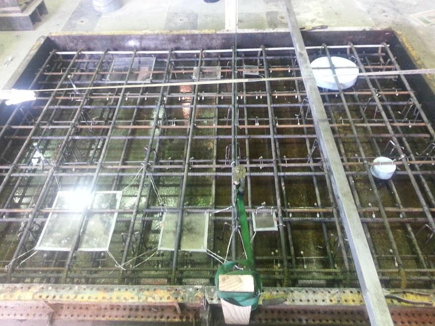 bridge decks. The presence of significant rebar cages as used in typical bridge deck designs can complicate the propagation of stress waves in impact-echo testing.