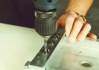 Slide the drill jig holes over the line on the web and drill two holes 5mm 5.1mm.