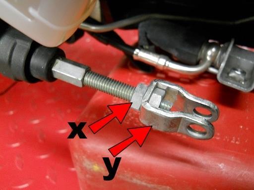 Hold nut (x) with a wrench and the clevis (y) with pliers and remove the clevis but leave nut (x)