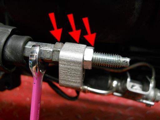 Thread the nut all the way to the end and tighten, using a wrench as shown to hold the plunger from