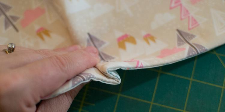 Sew the Pocket Piece: If you are using a snap (or magnetic snap) apply the remaining snap half the the center of the pocket piece on the side with fusible fleece (this will be the exterior).