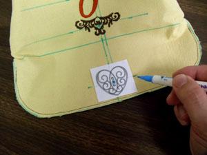 We are adding a buttonhole design to the front flap to create the closure. For more information on using buttonhole designs, click here.