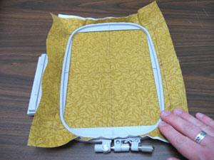 Spray a piece of cutaway stabilizer with temporary adhesive and smooth the fabric on top.