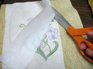 When the design has finished, trim away the excess stabilizer on the back of the embroidery.