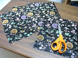 To prepare the fabric for the side panels of the outer shell, cut four pieces of the brocade