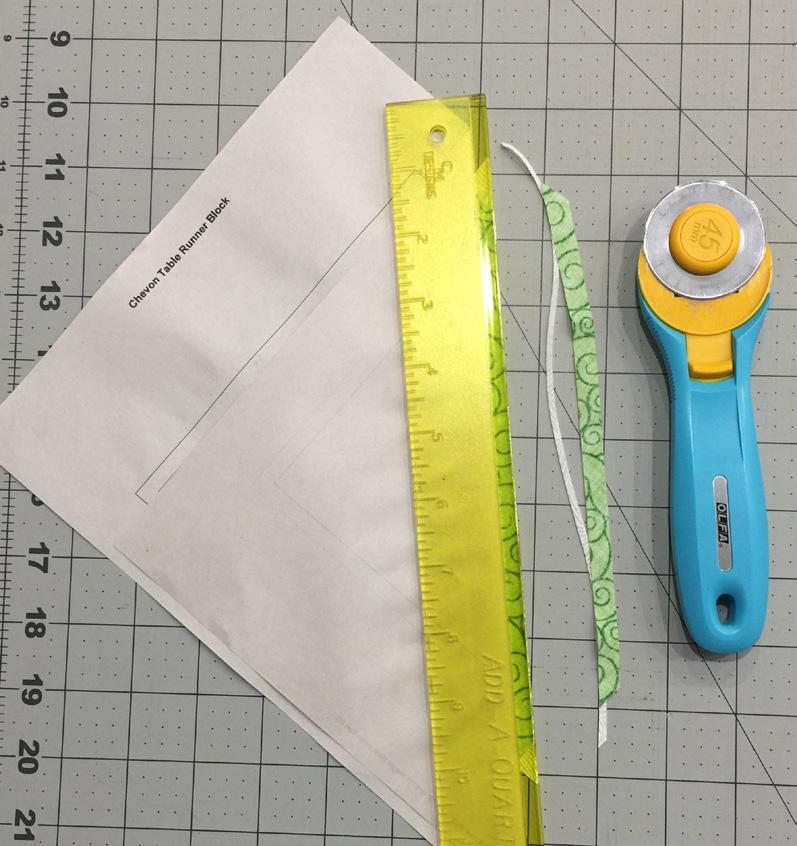 10. Boot the Add-A-Quarter ruler up against the seam allowance and trim the small amount of excess fabric away with your