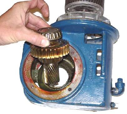 Using a soft blow hammer, gently tap Flange Cover and carefully pry from Flanged