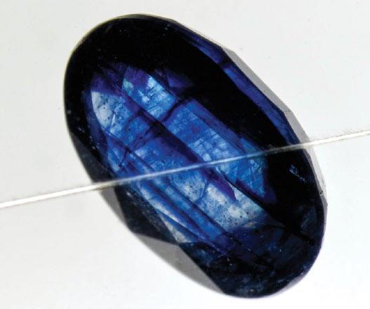 Natural, heat-treated, Ti-diffusion treated and synthetic sapphires will not show red through the Chelsea filter. The two stones in the above photo without red are Verneuil synthetic sapphires.