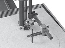 On this bandsaw the fence can be attached to both the front and rear of the work table, by a single screw which engages with the end of the table, holding the rip fence firmly at the desired location.