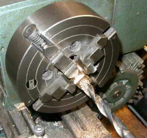 The bearing was repositioned and centered in the chuck using the dial
