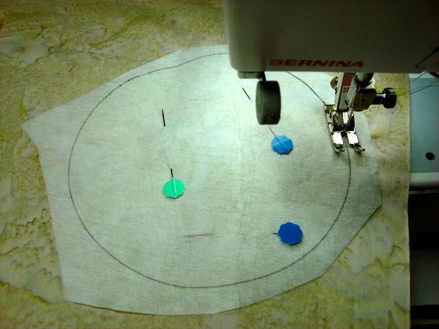 Place and pin interfacing circle on right side of the snowman fabric.