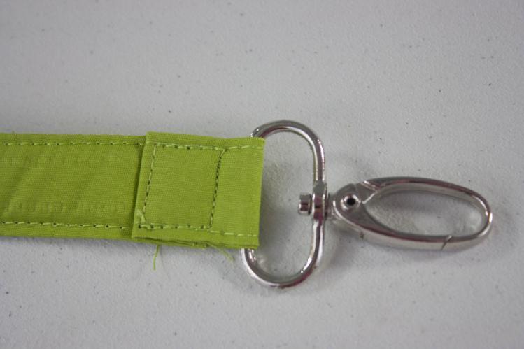 Slide a swivel clip onto each end of the Strap at the second crease.