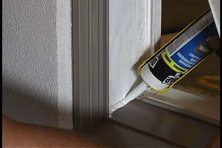 Use an acrylic latex primer and caulk to seal the miter joint behind the sash track.
