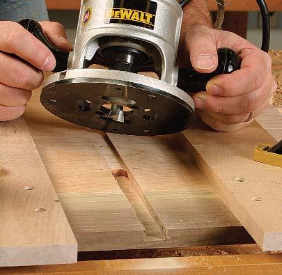 After routing all of the dadoes, use a 4-in. dovetail bit to cut slots for the front and back drawer s.