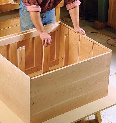 In this dresser, the case top is joined to the sides with through-dovetails, while the bottom is joined with half-blind dovetails.