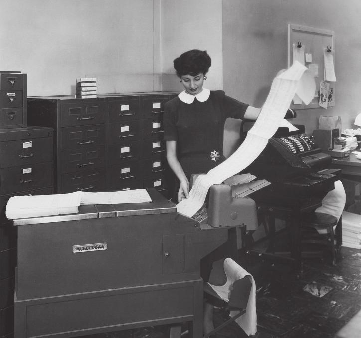 Clerks in the Collections Department in the 1940s used one of the earliest copying machines, the Eastman Kodak Recordak, to photograph checks and other bank records on 16-millimeter film for backup