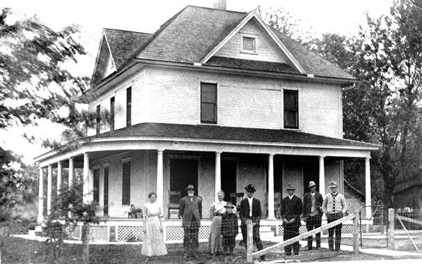 Last home of David and Chelley Beals, located southwest of Baxter, Iowa. The people in front of the house are unidentified.