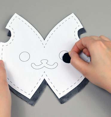 Align the applique piece on top where the placement markings are, then carefully pull the paper pattern away