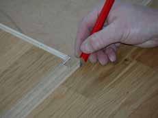 With a pen, mark where to cut 8-10 mm from the end of the previous board, to make it easier to get the board into