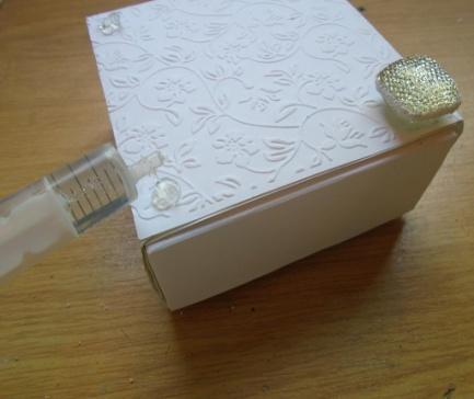 Add some 3d glue on each corner of the base of the box and add the prepared dazzlers over the top.