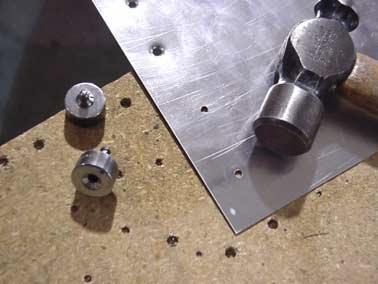 male die can be positioned through a hole in the workbench, hammer down on the female die to dimple