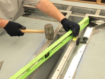 STEP 8: Lower Rails into Wet Setting Bed Place the first length of FP rails into the wet, epoxymortar setting