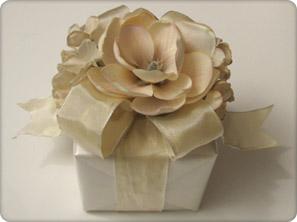 Small Box Difficulty Medium Materials: Cream, frosted wrapping paper Cream floral scrapbooking or craft paper 1-1/2-inch wide, cream wired satin ribbon 1 large cream flower, stem removed 2 bunches of