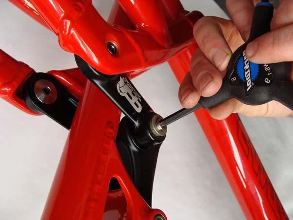2. b) Use the same Allen wrench to remove the tapered washer from the pivot axle.
