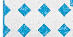 Machine appliqué edges of appliqué shapes with a narrow zigzag or narrow satin stitch. 7. Layout quilt blocks according to diagram. 8.