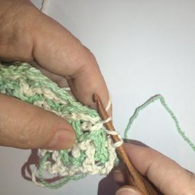 In this case, I am pushing the white, through the green window, towards the front. Insert your hook into the stitch as usual, making very sure you catch both the front and the back loop.