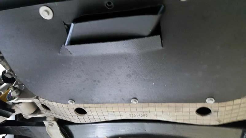 11.) Re-install Front Compartment Air Deflector and drill holes through the lower tab of the Front