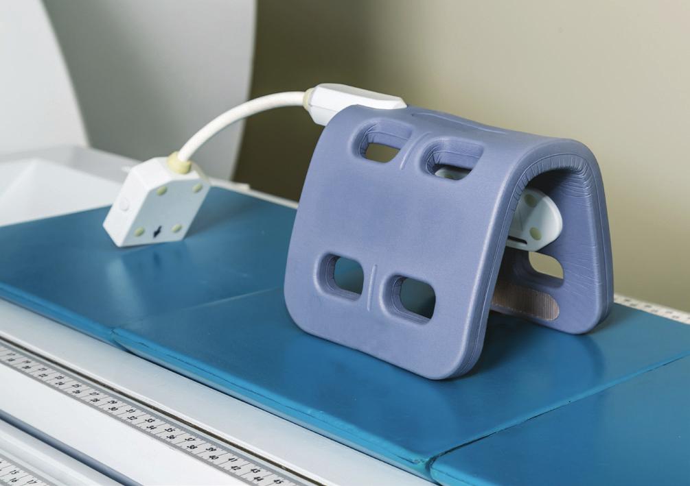 The V-shaped patient bed and spine coil is designed to facilitate imaging in dorsal recumbency and