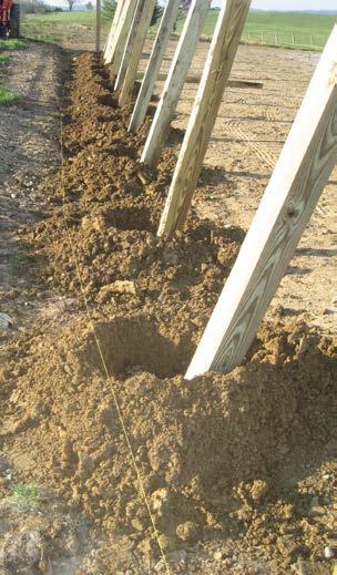 Effort was made to create holes approximately 4 feet deep. 6x6 treated posts 10 feet long were placed in each hole. Once the holes were dug, the next step was to pull a string line.