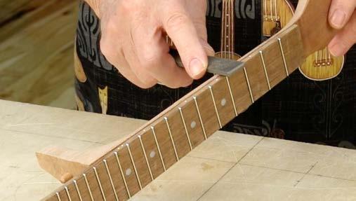 Level the frets Watch the video: PART 5 LEVELING THE FRETS Smooth the fretboard/neck transition The glue joint between the fretboard and neck needs to be smoothed to get a comfortable transition