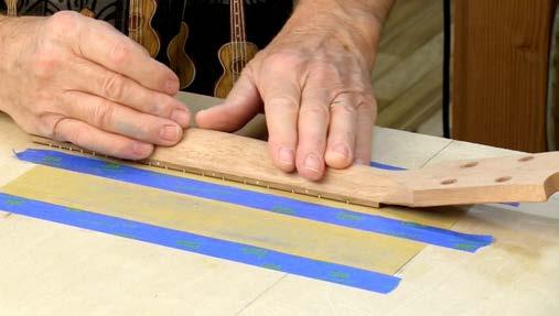 Use a flat file and sandpaper to slightly round the fretboard edge, blending it into the neck. At this stage, you re shaping, not final sanding.