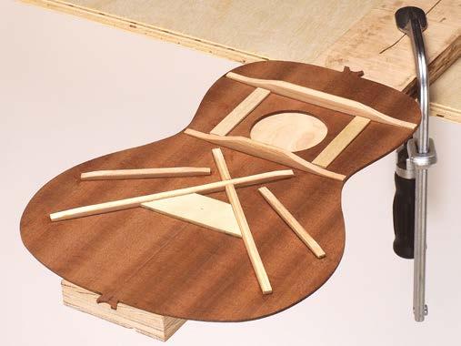 The bold black line on the plan drawing is the final shape of your uke. Attach blocks of wood to two of the corner braces, as shown in the photo (next page).