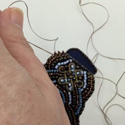 An optional small detail for the edging: on a long thread, tie a small knot near the end and imbed it inside of your beading somewhere near one end.