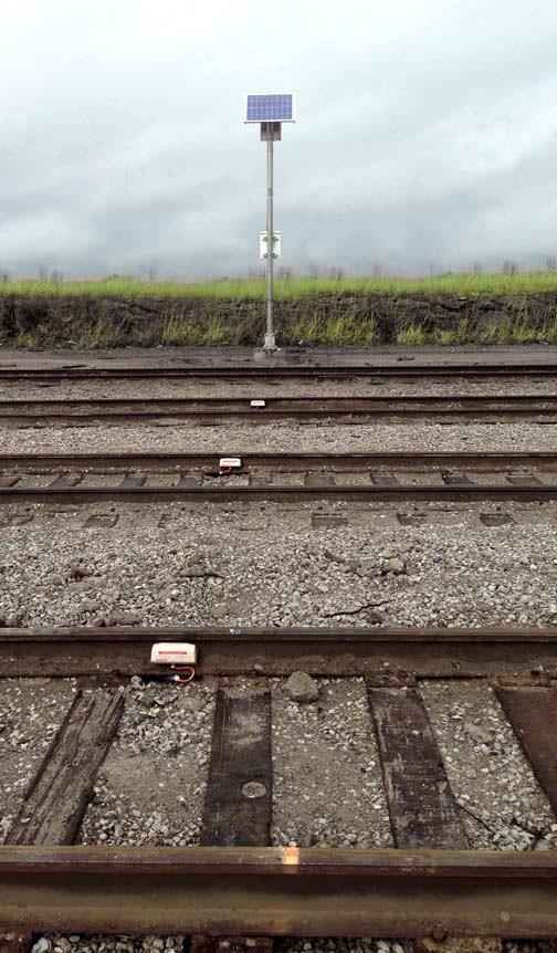 Track Circuit Magnetic coil wheel detector sensors attached to the track up to 1,200 feet from the crossing detect approaching trains, then wirelessly activate the