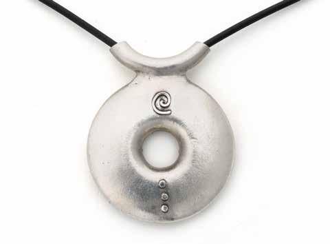 Use syringe clay to add decorative touches to the back of your pendant. Celorio added a spiral near the tube and three stacked dots. shapes for a few seconds.