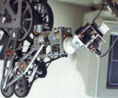The robotic manipulator consists of a 5-axis commercial robot, an instrumented passive-compliant wrist and a 16-by-16 tactile probe.