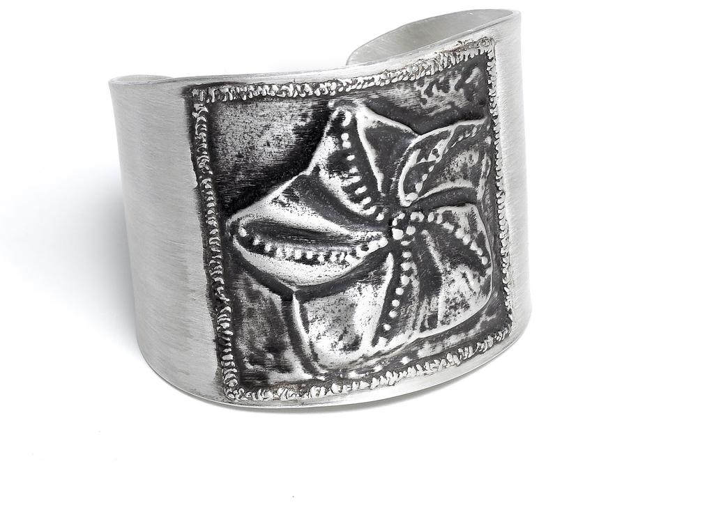 This 6 x 2-in. (15.2 x 5.1 cm) fine-silver cuff features a metal clay paper repoussé image of a bishop s cap cactus.