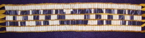 Wabanaki Confederacy Belt Not given. Beaded Length: 11.5 inches. Width: 2.5 inches. Total length with fringe: 31.5 inches. 71 columns by 5 rows. Total: 355 beads.